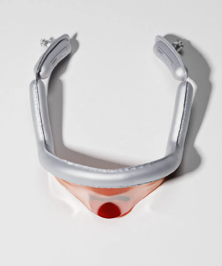Silver inflatable sunglasses with orange visor on a studio floor. Inflatable eyewear sunglasses by All Design Lab.