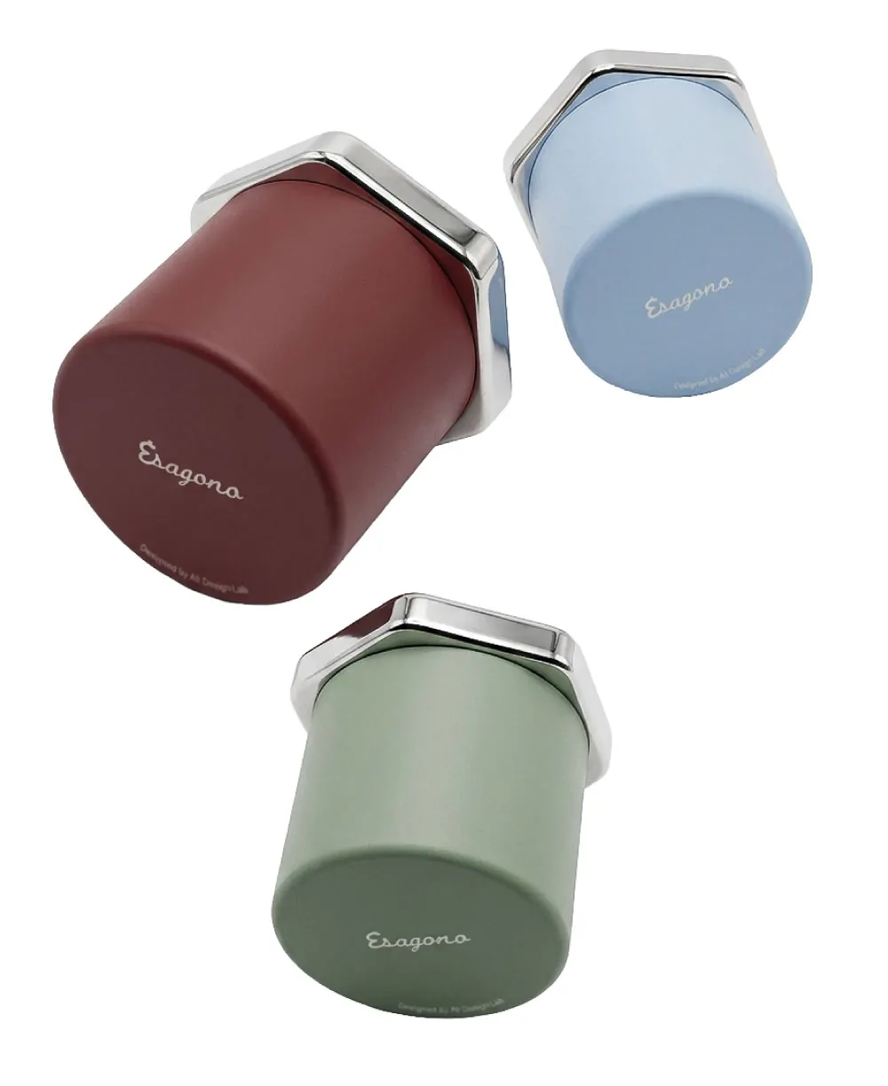 Three Esagono espresso cups in burgundy, slate blue, and sage green powder-coated aluminum, floating arrangement showing colorway options, mirror-polished stainless steel collar detail